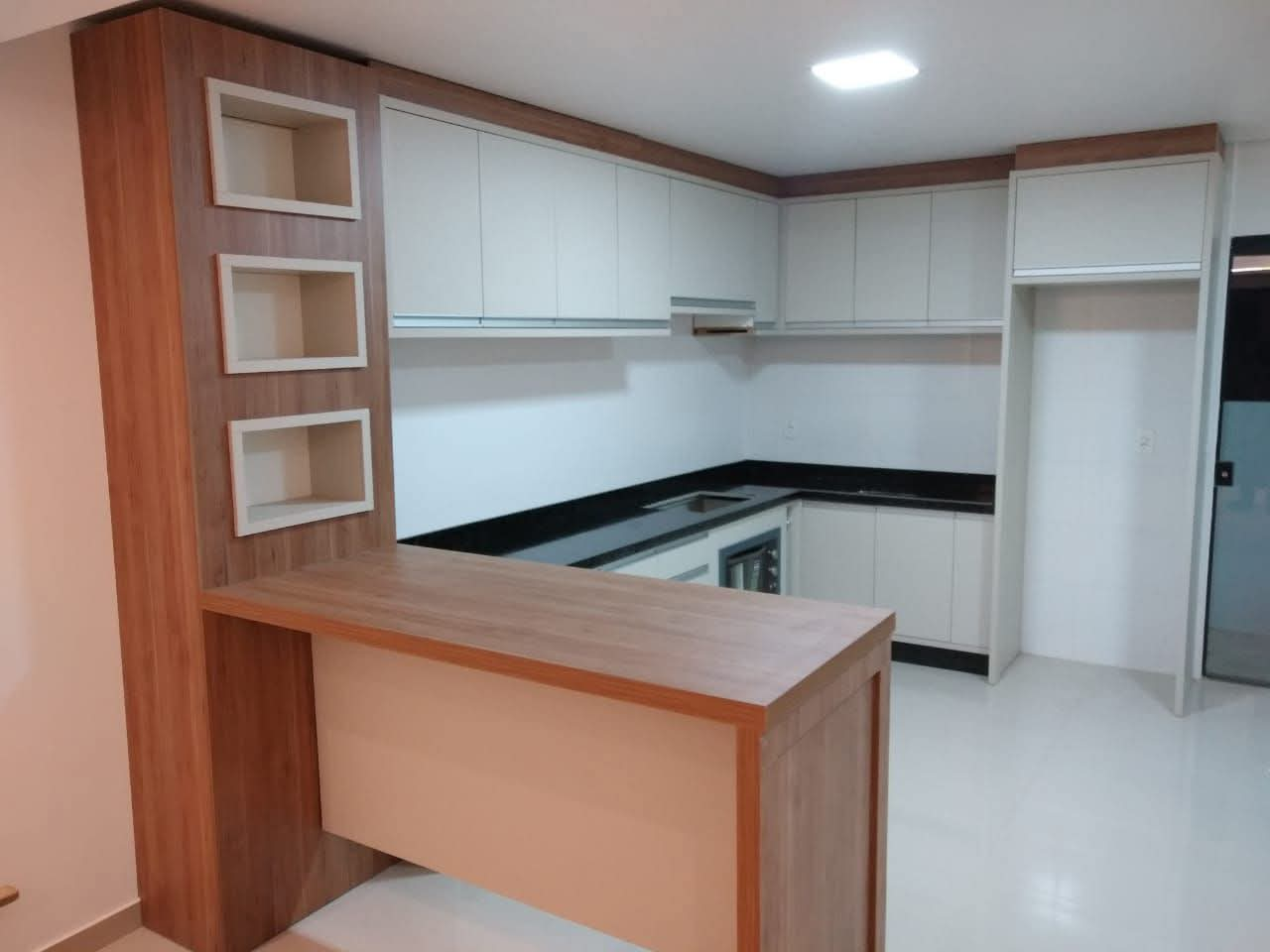 Cozinha planejada com bancada em madeira